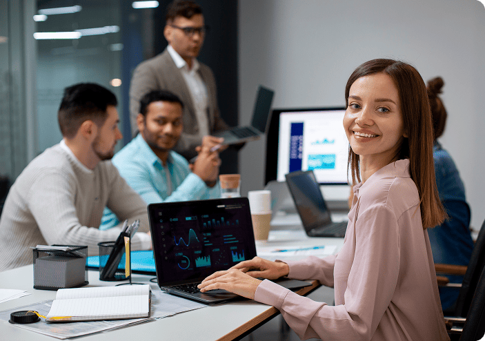Product team reviewing dashboards on laptops in an office