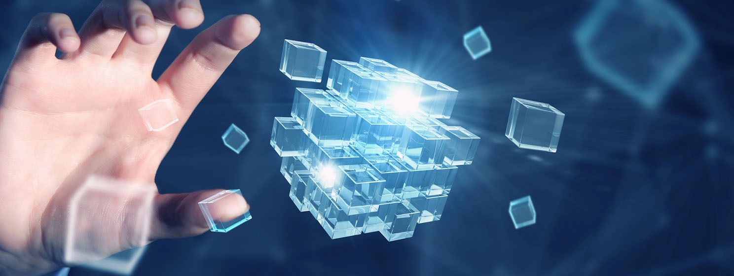 Hand arranging glowing blocks of a decentralized system
