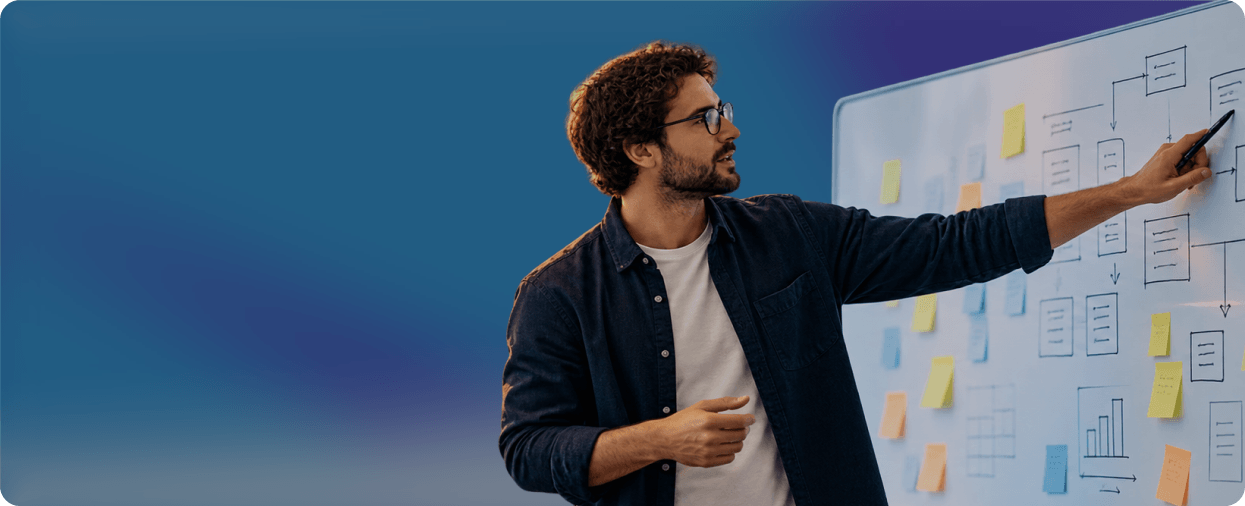 Engineer sketching a workflow on a whiteboard