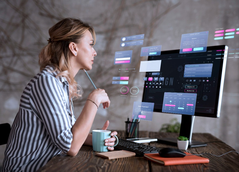 Designer reviewing a holographic UI at her desk
